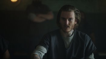 Movie still from “Peacemaker” (2022), created by James Gunn – A person with long hair; Close Up shot, Over the shoulder angle