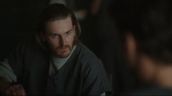 Movie still from “Peacemaker” (2022), created by James Gunn – A person with long hair; Close Up shot, Over the shoulder angle