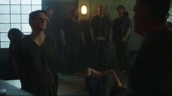 Movie still from “Peacemaker” (2022), created by James Gunn – A group of men standing in a room; Medium shot, Over the shoulder angle