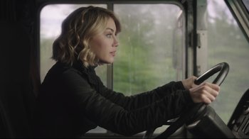 Movie still from “Peacemaker” (2022), created by James Gunn – A woman sitting in the driver's seat of a bus; Close Up shot, Low angle