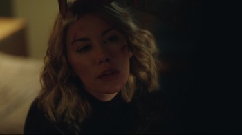 Movie still from “Peacemaker” (2022), created by James Gunn – A person wearing a black shirt; Close Up shot, Over the shoulder angle