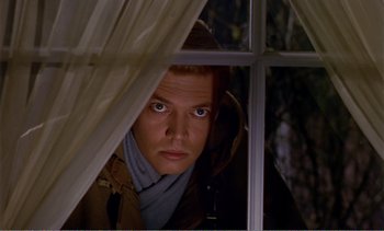 Movie still from “Peeping Tom” (1960), directed by Michael Powell – A man looking out of a window at night; Close Up shot, Low angle