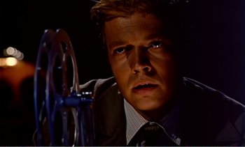 Movie still from “Peeping Tom” (1960), directed by Michael Powell – A person wearing a suit and tie; Close Up shot, Low angle