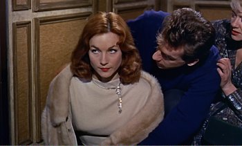 Movie still from “Peeping Tom” (1960), directed by Michael Powell – A man and a woman are looking at each other; Medium shot, Over the shoulder angle