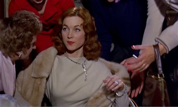 Movie still from “Peeping Tom” (1960), directed by Michael Powell – A woman with red hair wearing a fur coat; Medium shot, High angle
