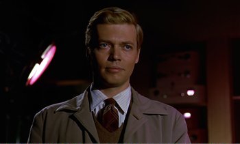 Movie still from “Peeping Tom” (1960), directed by Michael Powell – A person wearing a suit and tie; Close Up shot, Low angle