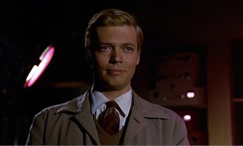 Movie still from “Peeping Tom” (1960), directed by Michael Powell – A person wearing a suit and tie; Close Up shot, Low angle