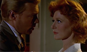 Movie still from “Peeping Tom” (1960), directed by Michael Powell – A man and a woman face to face in front of a wall; Close Up shot, Over the shoulder angle