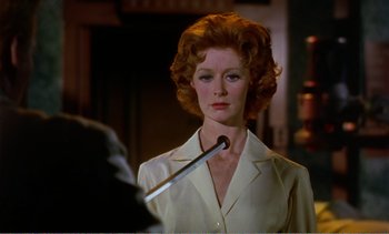 Movie still from “Peeping Tom” (1960), directed by Michael Powell – A person holding a knife; Close Up shot, Over the shoulder angle