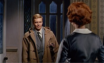 Movie still from “Peeping Tom” (1960), directed by Michael Powell – A man in a brown coat is looking at a woman in a brown coat; Medium shot, Over the shoulder angle
