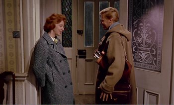 Movie still from “Peeping Tom” (1960), directed by Michael Powell – A man and a woman standing next to each other; Medium shot, High angle