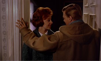 Movie still from “Peeping Tom” (1960), directed by Michael Powell – A man and a woman standing next to each other; Medium shot, Over the shoulder angle