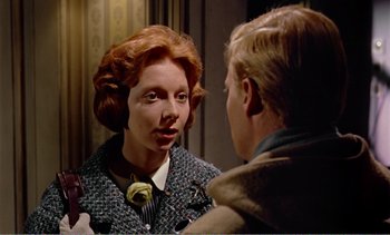 Movie still from “Peeping Tom” (1960), directed by Michael Powell – A woman is looking at a man in the mirror; Close Up shot, Over the shoulder angle