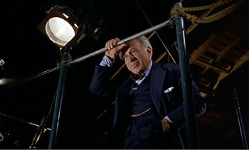 Movie still from “Peeping Tom” (1960), directed by Michael Powell – An older man wearing a suit and tie; Medium shot, Low angle