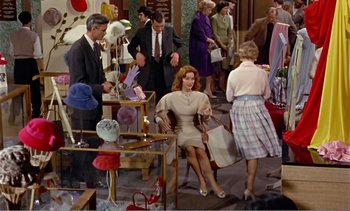 Movie still from “Peeping Tom” (1960), directed by Michael Powell – A group of people standing around a room; Wide shot, High angle