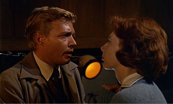 Movie still from “Peeping Tom” (1960), directed by Michael Powell – A man and a woman talking to each other; Close Up shot, Over the shoulder angle