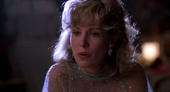 Movie still from “Peggy Sue Got Married” (1986), directed by Francis Ford Coppola – A person wearing a dress; Close Up shot, Low angle