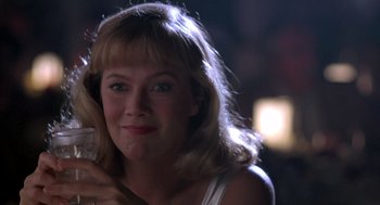 Movie still from “Peggy Sue Got Married” (1986), directed by Francis Ford Coppola – A person holding a glass of wine; Close Up shot, Low angle