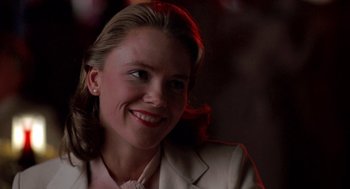 Movie still from “Peggy Sue Got Married” (1986), directed by Francis Ford Coppola – A woman with blonde hair wearing a white jacket; Close Up shot, Low angle