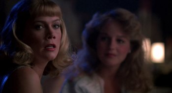 Movie still from “Peggy Sue Got Married” (1986), directed by Francis Ford Coppola – Two women are looking at each other in a dark room; Close Up shot, Over the shoulder angle