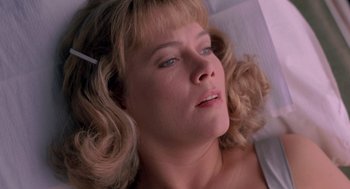 Movie still from “Peggy Sue Got Married” (1986), directed by Francis Ford Coppola – A person laying on a bed; Close Up shot, Overhead angle