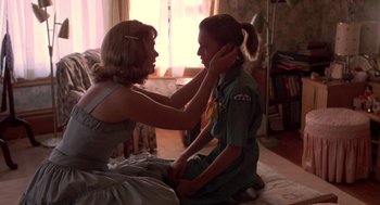 Movie still from “Peggy Sue Got Married” (1986), directed by Francis Ford Coppola – A woman and a girl sitting on the floor; Medium shot, Over the shoulder angle