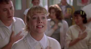 Movie still from “Peggy Sue Got Married” (1986), directed by Francis Ford Coppola – A woman in a white shirt is looking up at the sky; Close Up shot, Low angle