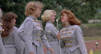 Movie still from “Peggy Sue Got Married” (1986), directed by Francis Ford Coppola – A group of three women standing next to each other; Medium shot, Low angle