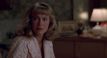 Movie still from “Peggy Sue Got Married” (1986), directed by Francis Ford Coppola – A person wearing a pink jacket; Close Up shot, Over the shoulder angle