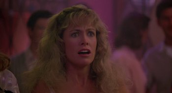 Movie still from “Peggy Sue Got Married” (1986), directed by Francis Ford Coppola – A person with long blonde hair; Close Up shot, Low angle