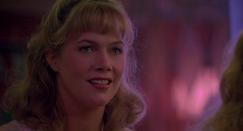 Movie still from “Peggy Sue Got Married” (1986), directed by Francis Ford Coppola – A person wearing a white shirt; Close Up shot, Over the shoulder angle