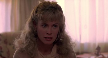 Movie still from “Peggy Sue Got Married” (1986), directed by Francis Ford Coppola – A person with long blonde hair; Close Up shot, Over the shoulder angle