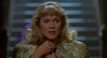 Movie still from “Peggy Sue Got Married” (1986), directed by Francis Ford Coppola – A person with blond hair wearing a dress; Close Up shot, Low angle