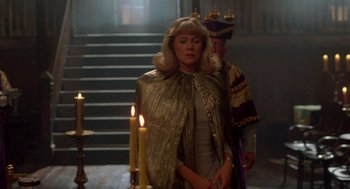 Movie still from “Peggy Sue Got Married” (1986), directed by Francis Ford Coppola – A woman standing next to a man with candles; Medium shot, Over the shoulder angle