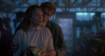 Movie still from “Peggy Sue Got Married” (1986), directed by Francis Ford Coppola – A man and a woman standing next to each other; Medium shot, Over the shoulder angle