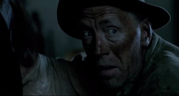 Movie still from “Pelle the Conqueror” (1987), directed by Bille August – A person wearing a hat; Close Up shot, Over the shoulder angle