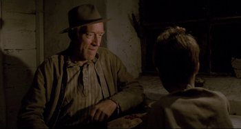 Movie still from “Pelle the Conqueror” (1987), directed by Bille August – An older man sitting at a table with a young boy; Close Up shot, Over the shoulder angle