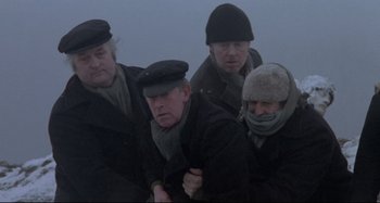 Movie still from “Pelle the Conqueror” (1987), directed by Bille August – A group of men standing next to each other on top of a hill; Medium shot, High angle