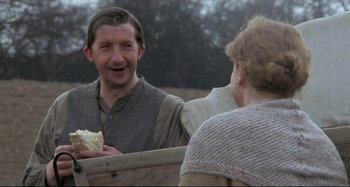 Movie still from “Pelle the Conqueror” (1987), directed by Bille August – A man and a woman are talking to each other; Medium shot, Over the shoulder angle