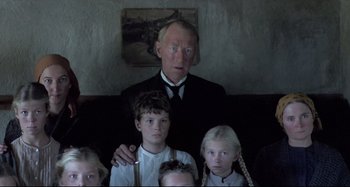 Movie still from “Pelle the Conqueror” (1987), directed by Bille August – A group of children and an old man in front of a painting; Medium shot, Low angle