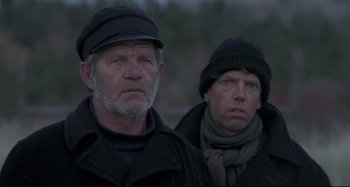 Movie still from “Pelle the Conqueror” (1987), directed by Bille August – Two men in winter clothing looking at the camera; Close Up shot, Low angle