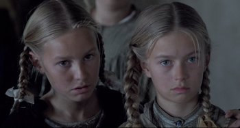 Movie still from “Pelle the Conqueror” (1987), directed by Bille August – Two young girls are looking at the camera; Close Up shot, High angle