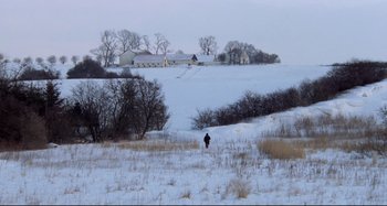 Movie still from “Pelle the Conqueror” (1987), directed by Bille August – A person is walking in a field in the snow; Extreme Wide shot, High angle