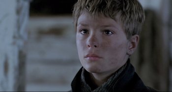 Movie still from “Pelle the Conqueror” (1987), directed by Bille August – A young boy is looking into the distance; Close Up shot, High angle