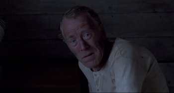 Movie still from “Pelle the Conqueror” (1987), directed by Bille August – An old man with a white shirt is looking at the camera; Close Up shot, High angle