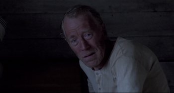 Movie still from “Pelle the Conqueror” (1987), directed by Bille August – An older man in a white shirt looking at the camera; Close Up shot, High angle