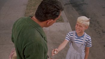 Movie still from “Pepe” (1960), directed by George Sidney – A man and a boy are shaking hands outside; Medium shot, High angle