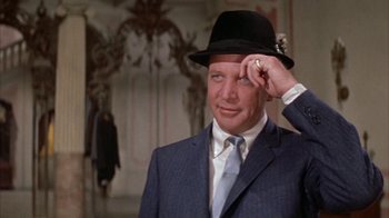 Movie still from “Pepe” (1960), directed by George Sidney – A person wearing a suit and a hat; Close Up shot, Low angle