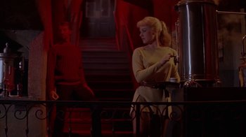 Movie still from “Pepe” (1960), directed by George Sidney – A woman standing in front of an easel in front of a man; Medium shot, Low angle