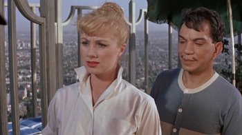 Movie still from “Pepe” (1960), directed by George Sidney – A woman standing next to a man on top of a building; Close Up shot, Over the shoulder angle